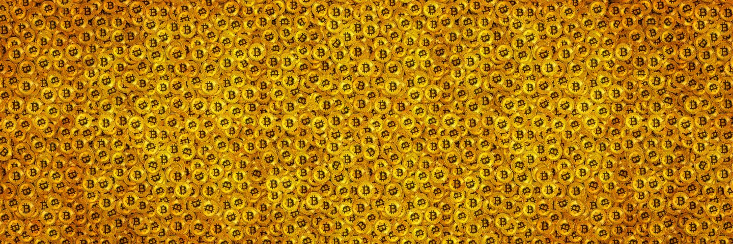 Pile of gold bitcoins panoramic banner background