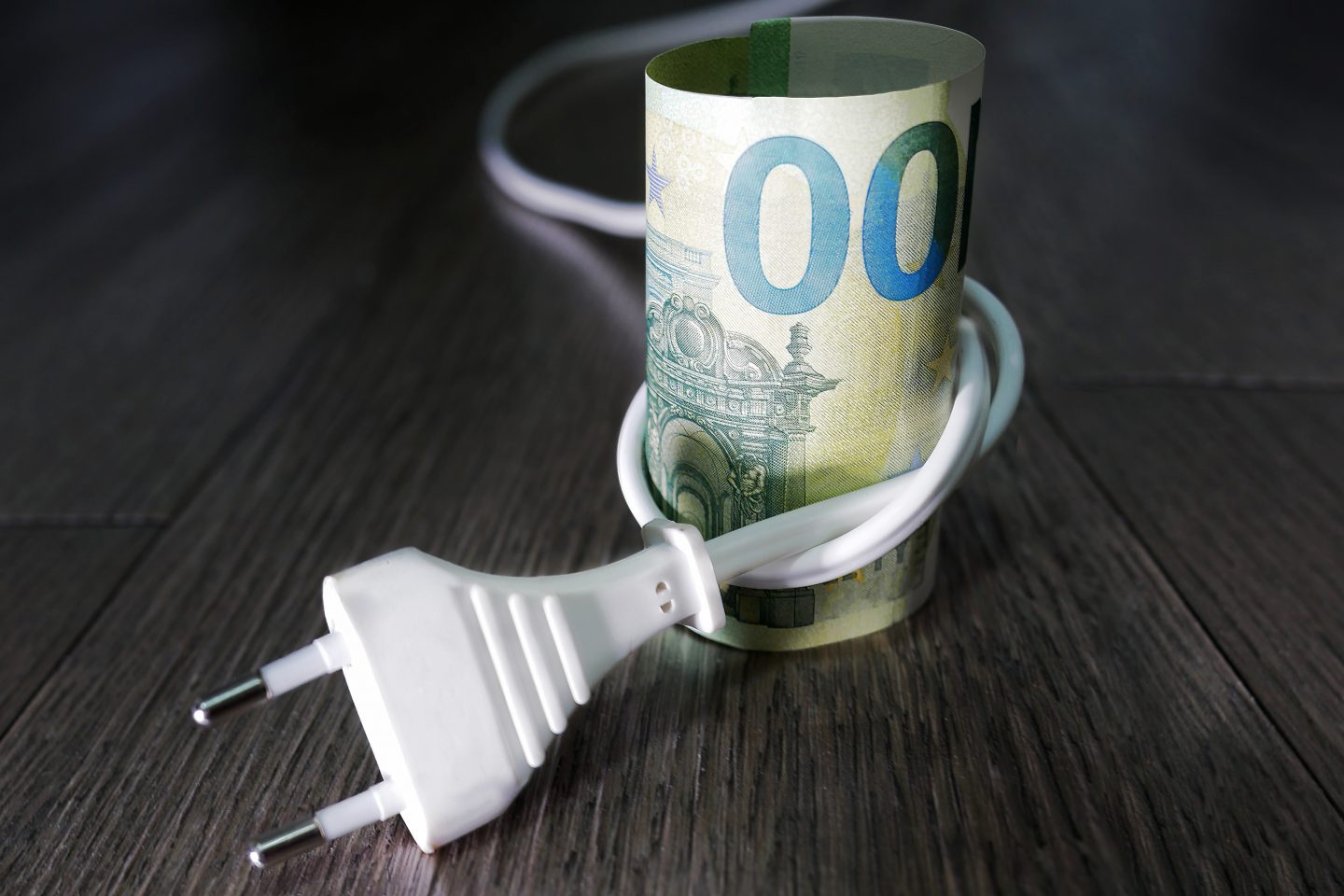 A euro banknote tied with a cable as a sign of savings and the e