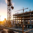 construction site for a large building with a clear blue sky background