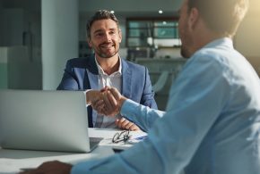 Business people, handshake and interview success or recruitment, employment and hiring in office. Corporate, men and executive shaking hands with new employee or collaboration on deal or partnership